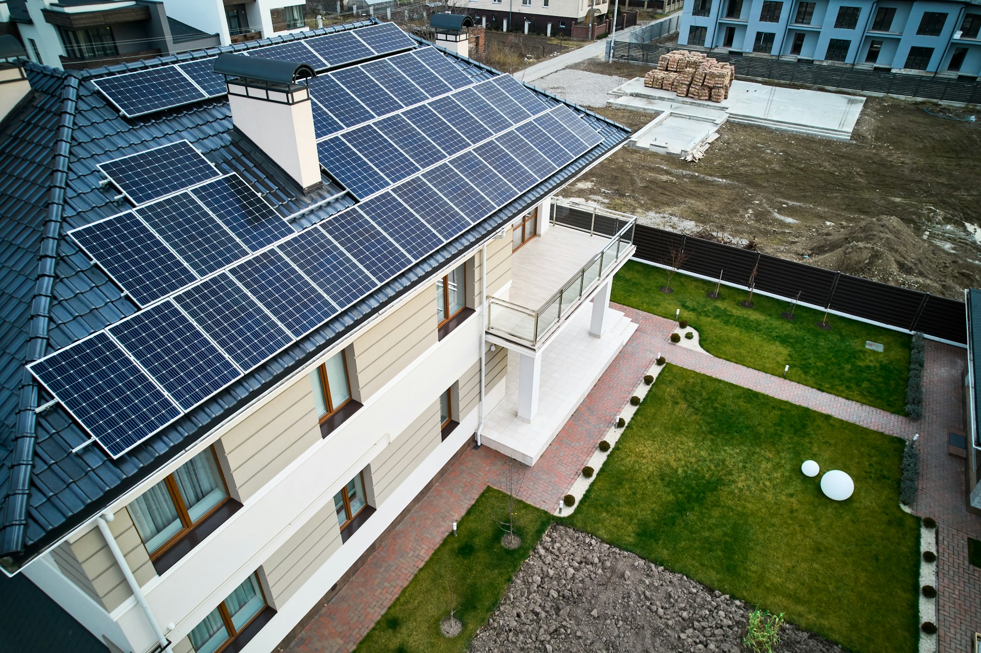 Modern residential house with solar panel system on roof.